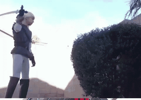 a woman is holding a sword in front of a tree