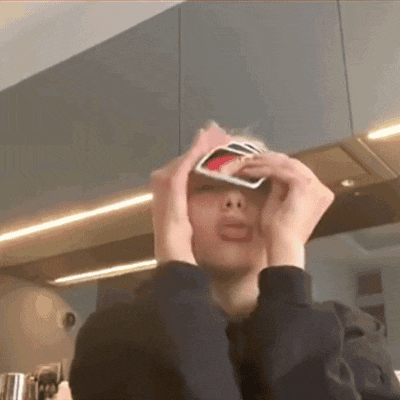 a person is holding a card in front of their eyes .
