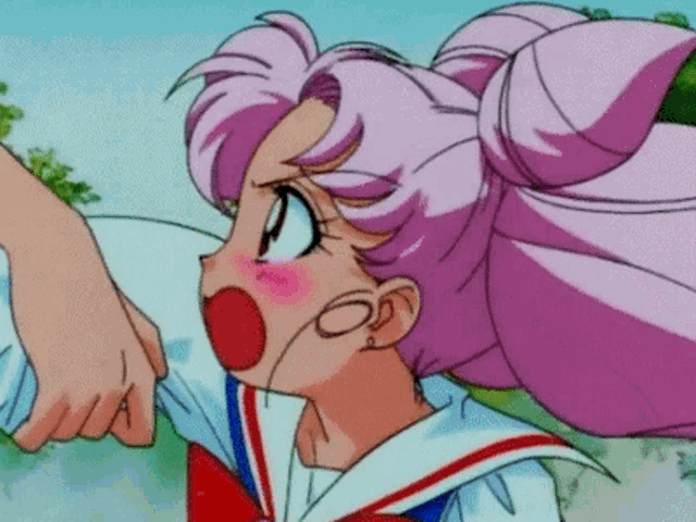 a girl with pink hair is pointing at someone 's hand