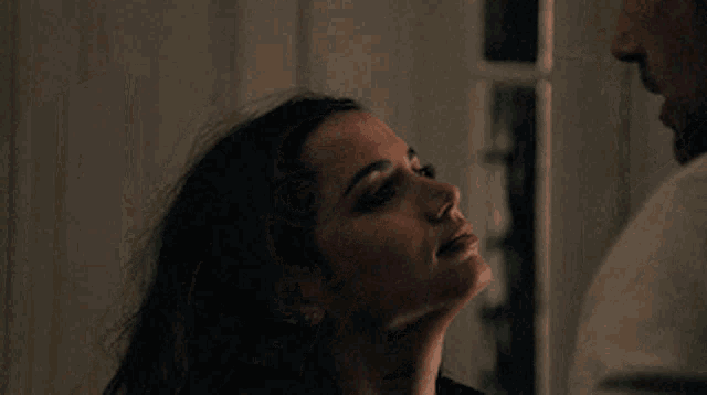 a close up of a woman looking at a man