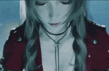 a close up of a woman 's face with her eyes closed and a choker around her neck