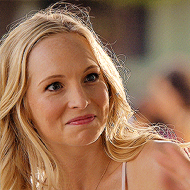 a close up of a woman 's face with a smile on her face