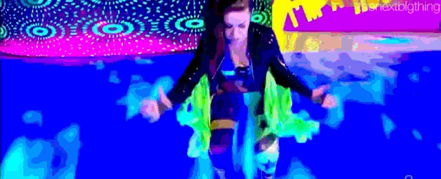 a woman is floating in a pool of water with a rainbow background .