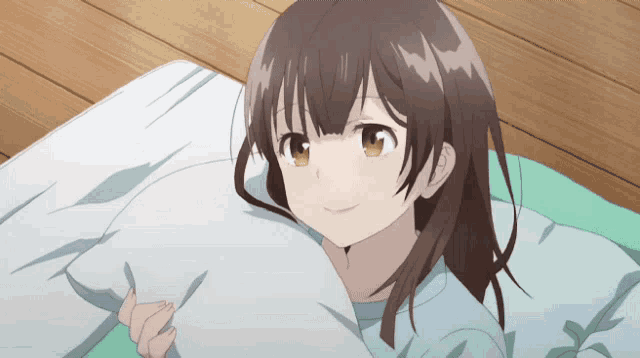 a girl laying on a bed holding a pillow