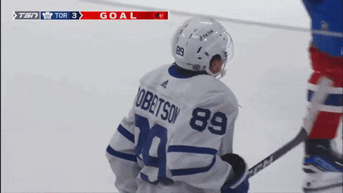 a hockey player with the number 89 on his jersey stands on the ice