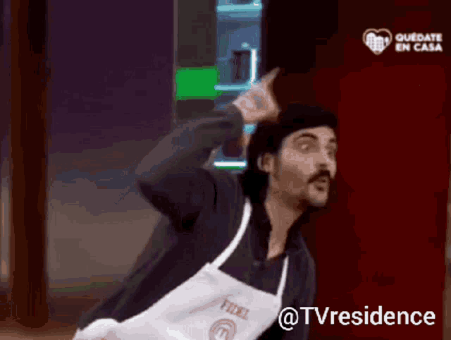a man with a beard wearing an apron that says fidel