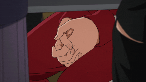 a close up of a person 's hands in a red shirt