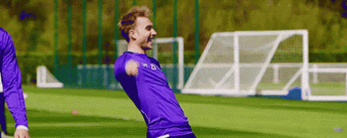 a man with a prosthetic arm is playing soccer on a field