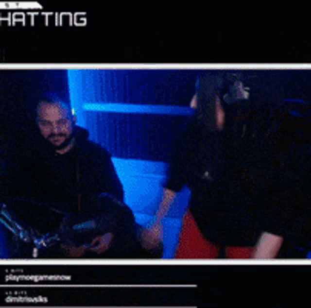 a man and a woman are sitting in front of a screen that says ' hatting '