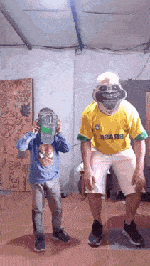 a man wearing a yellow shirt with the word brazil on it is standing next to a boy wearing a mask