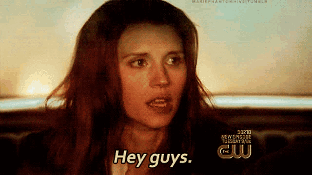 a woman says hey guys in front of a sign that says cw