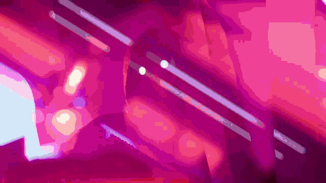 a person is standing in front of a purple and pink background