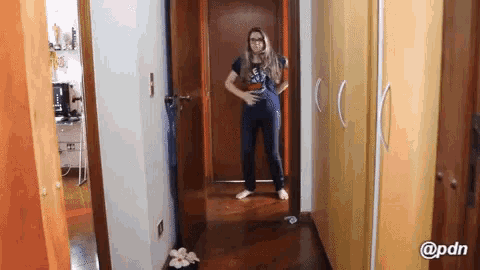 a woman standing in a hallway with a pdn logo on the bottom right