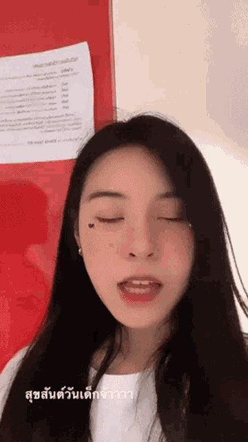 a woman with her eyes closed has a heart on her face