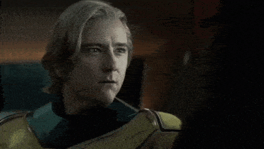 a man with blonde hair is wearing a yellow and green costume