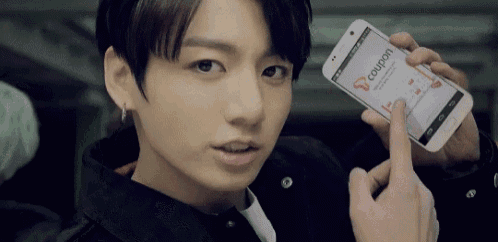 a close up of a person holding a cell phone with a coupon on it .