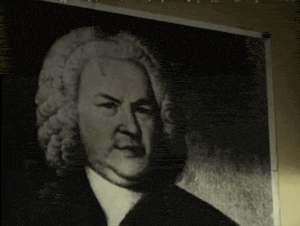 a black and white photo of a man with a wig on