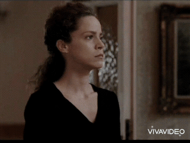 a woman in a black shirt is looking at another woman in a vivavideo clip