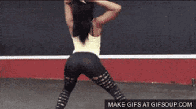 a woman is dancing in front of a make gifs at gifsoup.com advertisement