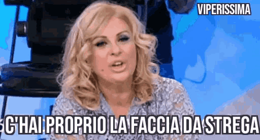 a woman is sitting in front of a camera with a caption that says ' viperissima ' on it