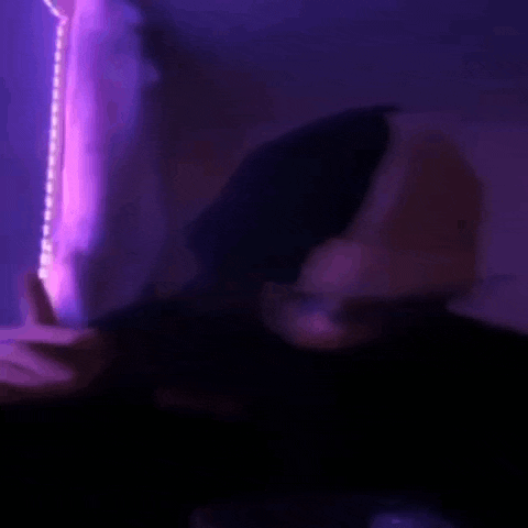 a blurry picture of a person dancing in a dark room .