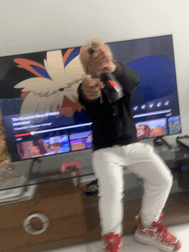 a person sitting in front of a tv with a cartoon on it