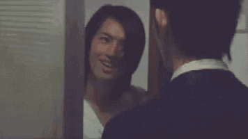 a man is looking at himself in a mirror .