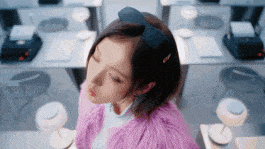 a woman in a purple fur coat is wearing a headband