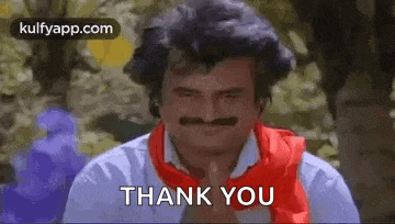 a man with a mustache is wearing a red scarf and saying `` thank you '' .
