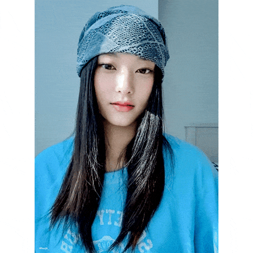 a woman wearing a bandana and a blue shirt that says yt3