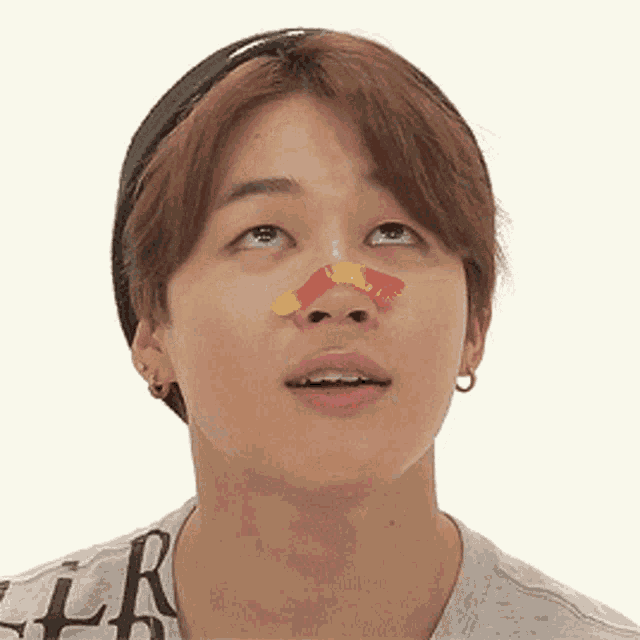 a close up of a person 's face with a sticker on their nose
