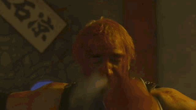 a man is doing a handstand in a dark room with a sign that says ' n.c. ' on it