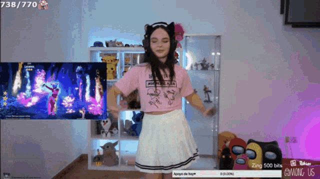 a girl in a pink shirt is dancing in front of a screen that says 738/770