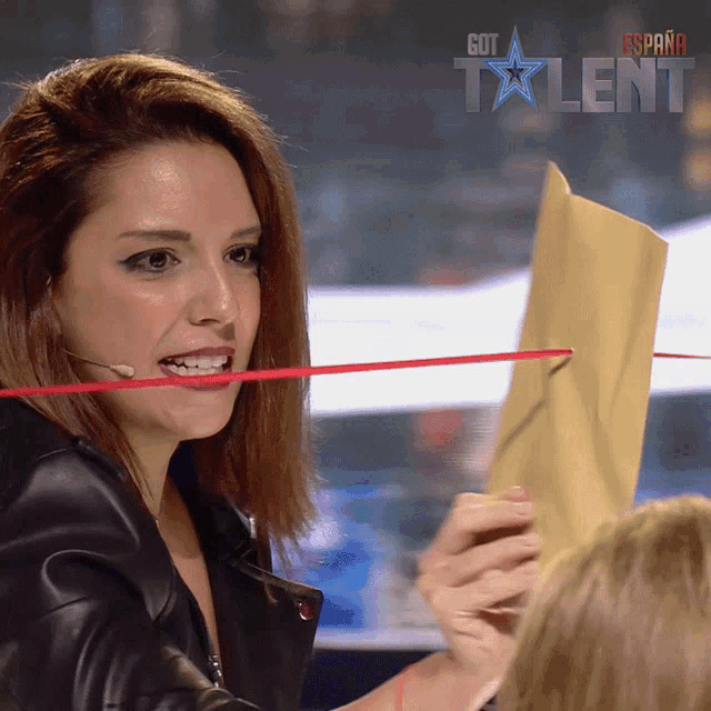a woman is holding a piece of paper in front of a got talent logo