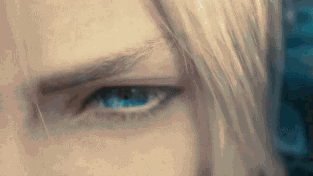 a close up of a man 's blue eyes with blonde hair .