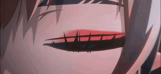 a close up of a person 's eyes with a red eyeshadow .