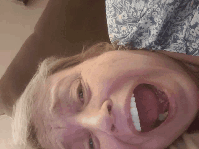 a close up of a woman making a face with her mouth open