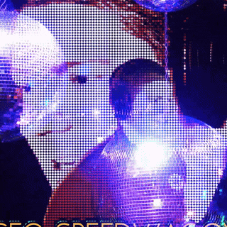 a disco ball is hanging from a chain in a dark room