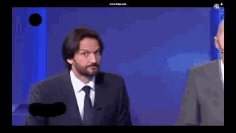 a man in a suit and tie is on a screen that says www.fnps.com