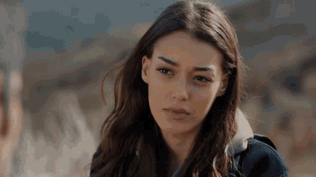 a close up of a woman 's face looking at the camera