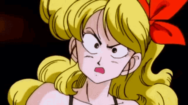 a cartoon girl with blonde hair and a red bow on her head .