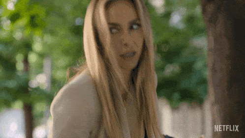 a woman is making a funny face in a netflix trailer .