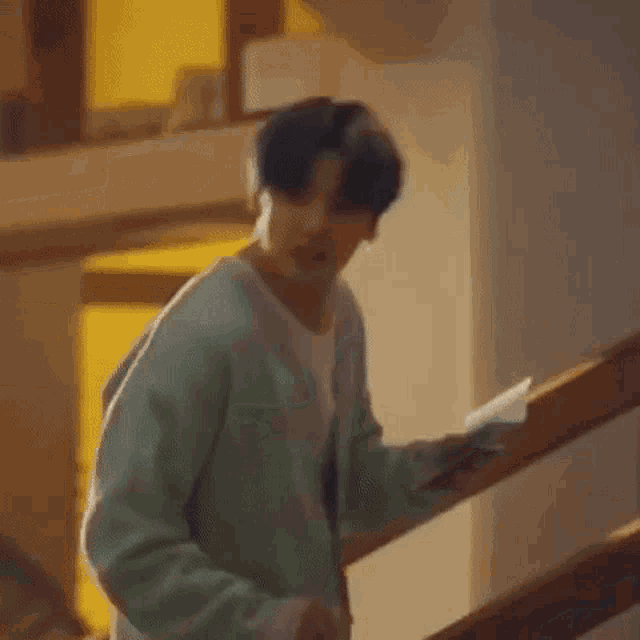a man is walking up a set of stairs in a house .