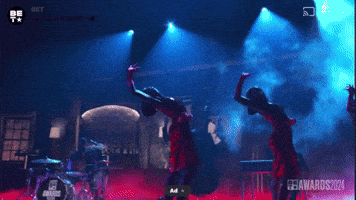 a group of people are dancing in front of a drum set that says drums
