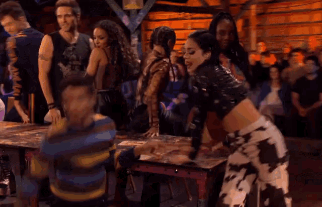 a group of people are standing around a table and one of them is wearing a shirt that says ' i love you '