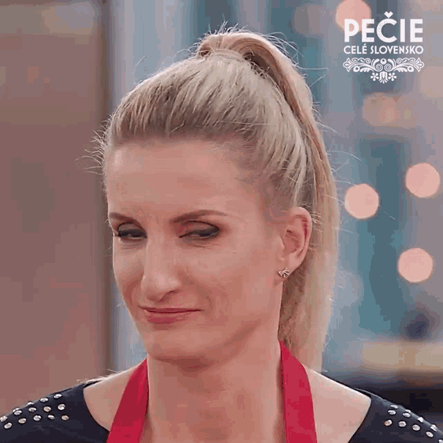 a woman wearing a red apron with the word pecie on the bottom right