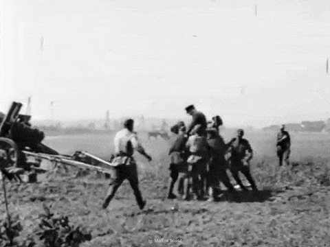 a black and white photo of a group of men in a field