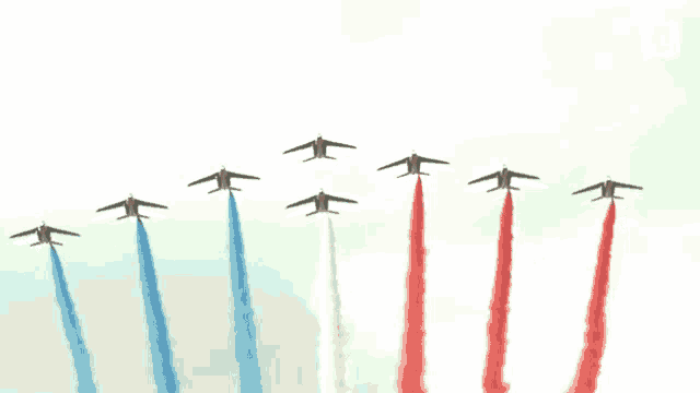 red white and blue jets flying in a row with smoke trails