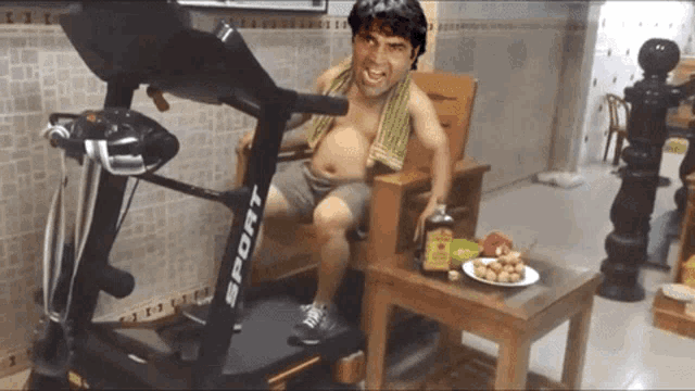 a man is sitting on a treadmill that says sport on it