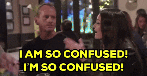 a man and a woman are sitting at a table and the man is saying i am so confused i 'm so confused